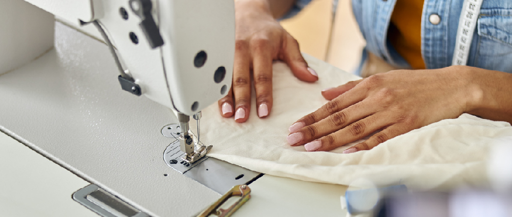 A woman sewing fabric, highlighting her craftsmanship in a cozy environment