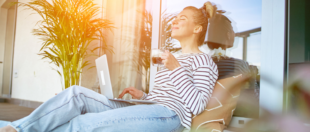 Relaxed woman enjoying a moment of peace while working on her goals, symbolizing self-care and balance