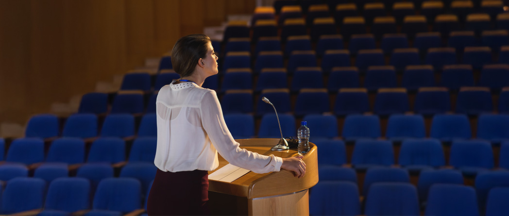 Person speaking into a mic alone in a quiet space, reflecting aloud — symbolizing reclaiming inner voice and clarity