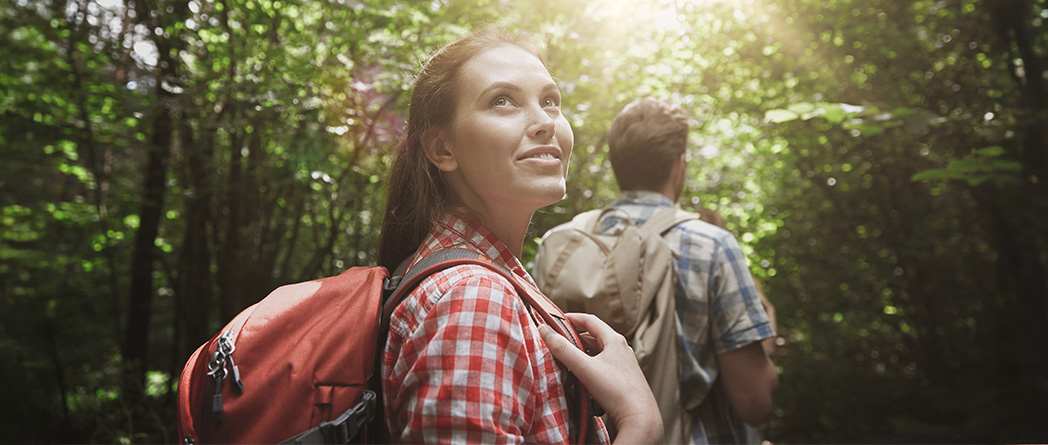 Person stopping midway on a hike or stairs, looking back to see how far they’ve come — symbolizing personal progress